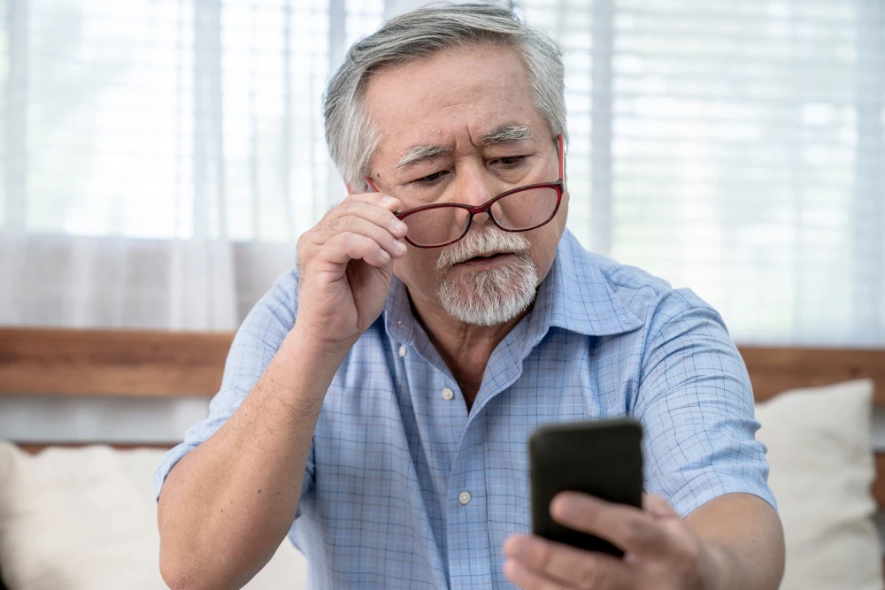 Elderly man experiencing blurred vision due to cataracts.